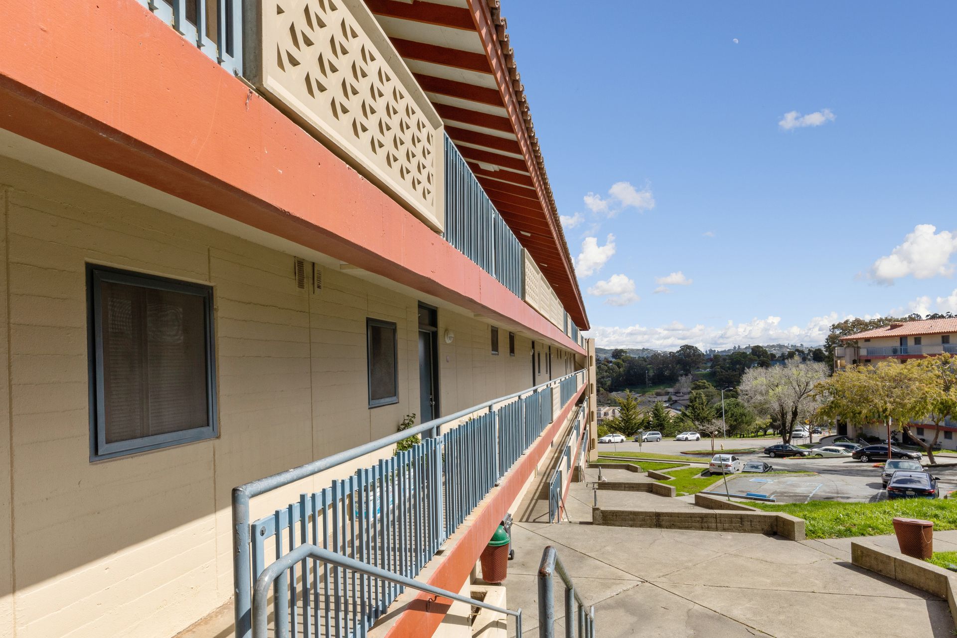 A large building with a balcony and stairs leading up to it.