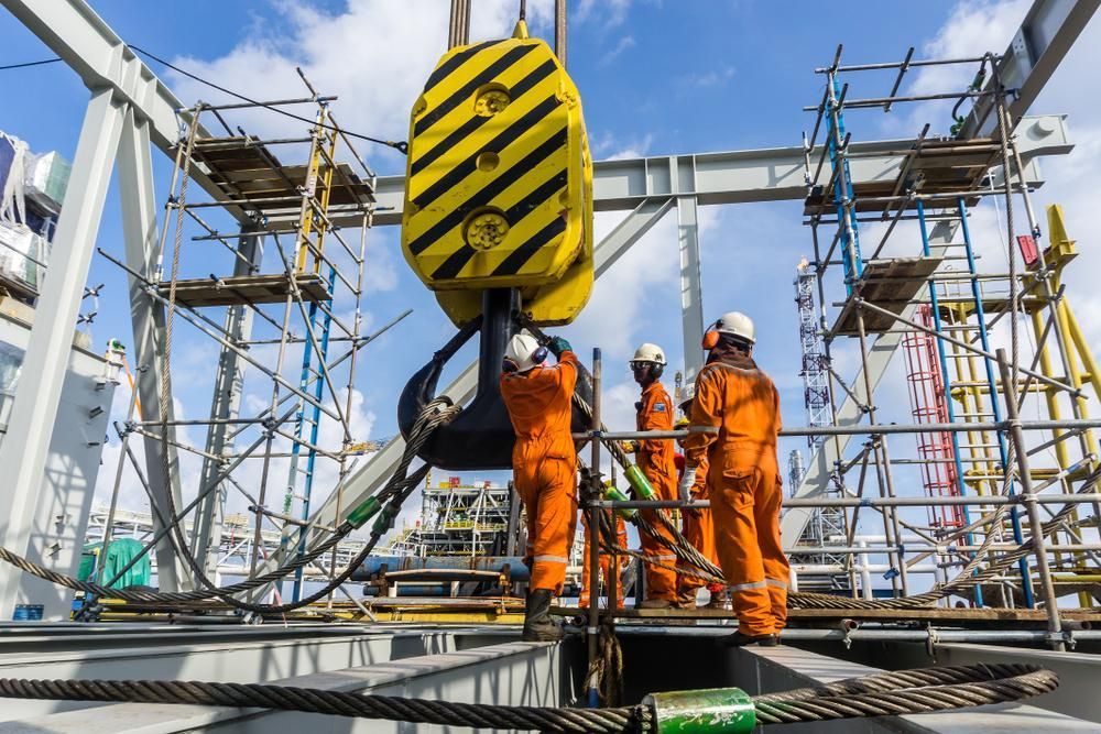 A Group of Construction Workers Are Working on A Large Crane — AMAC Cranes in Yandina, QLD 