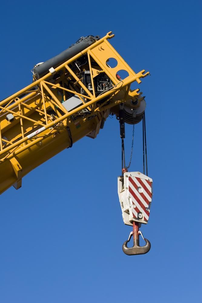 A Yellow Crane with A Hook Attached to It Against a Blue Sky — AMAC Cranes in Coolum Beach, QLD