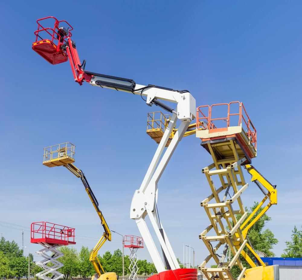 Three Scissor Lifts Are Parked Next to Each Other on A Sunny Day — AMAC Cranes in Yandina, QLD 