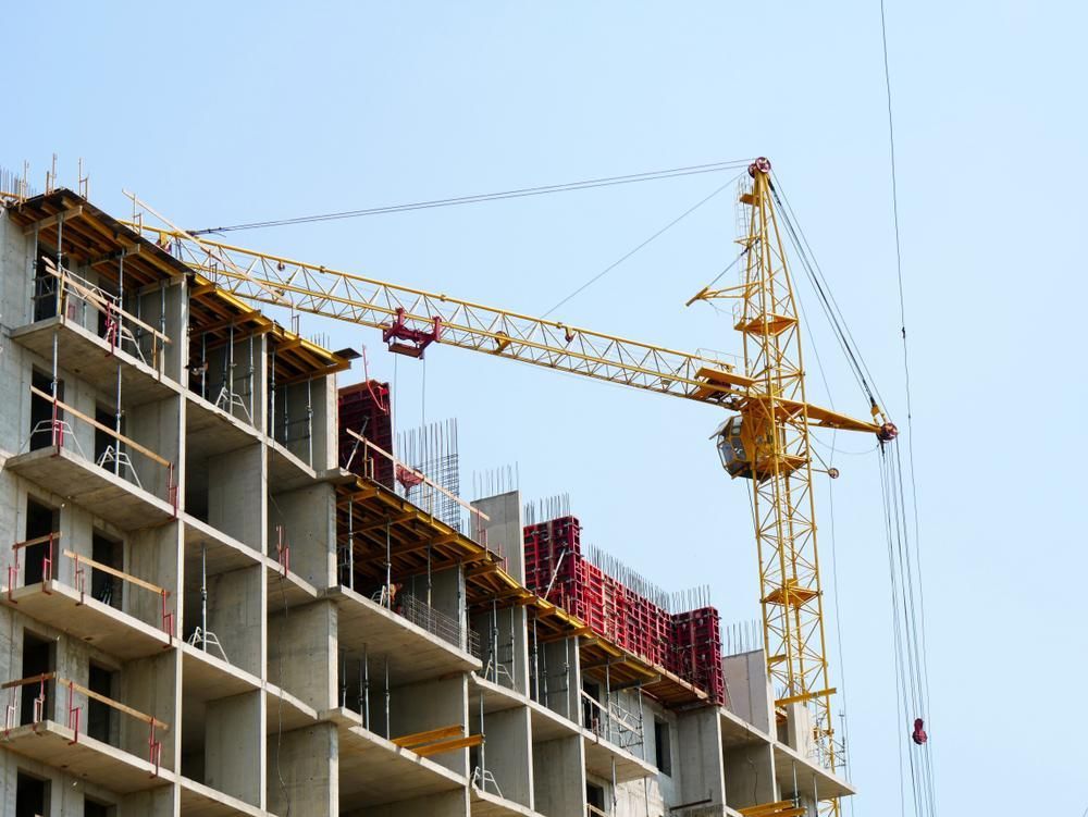 A Large Building Is Being Built with A Crane on Top of It — AMAC Cranes in Coolum Beach, QLD