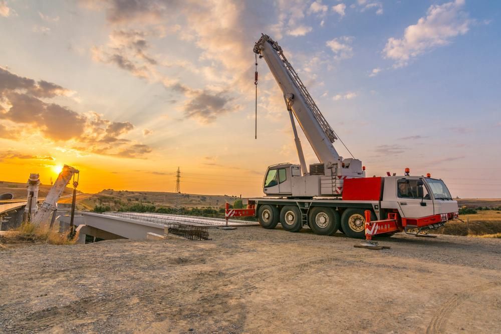 A Large Crane Is Parked on The Side of The Road at Sunset — AMAC Cranes in Coolum Beach, QLD