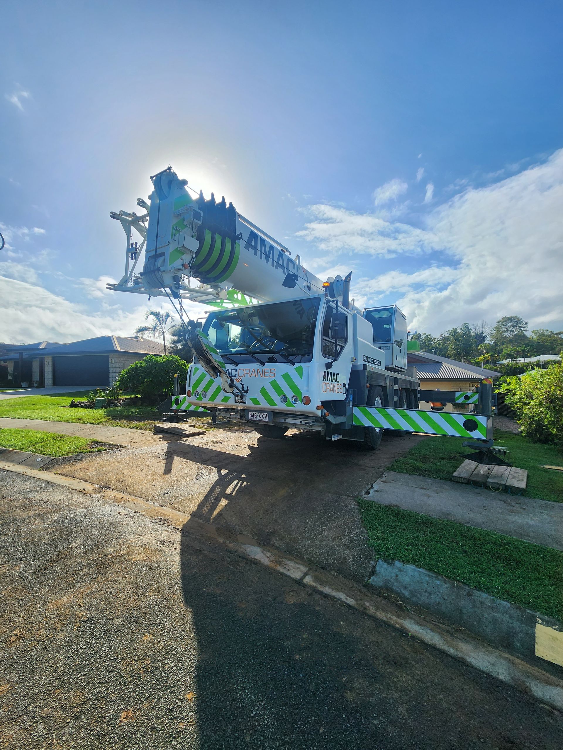 A White and Red Truck Is Parked on The Side of The Road — AMAC Cranes in Coolum Beach, QLD