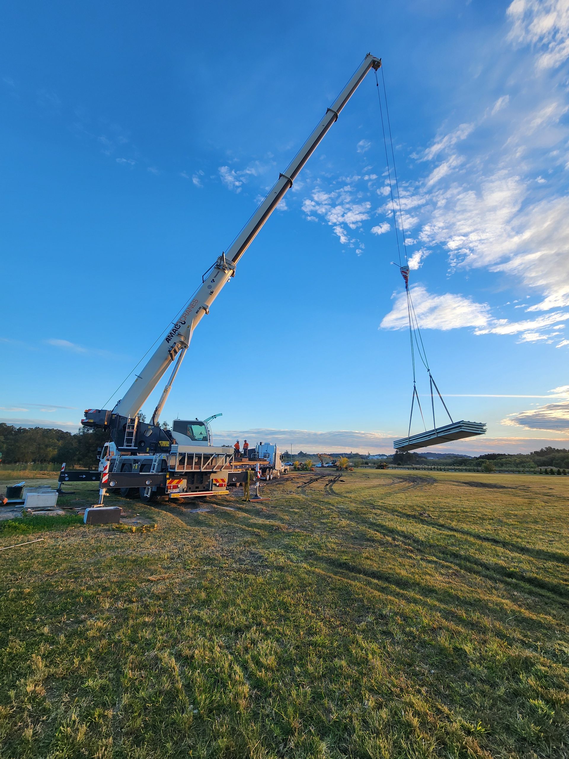 A Group of Construction Workers Are Working on A Building — AMAC Cranes in Coolum Beach, QLD