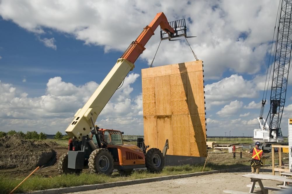 A Forklift Is Lifting a Large Piece of Wood — AMAC Cranes in Coolum Beach, QLD