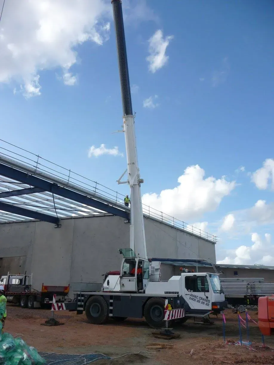 A Large Crane Is Parked in Front of A Building — AMAC Cranes in Coolum Beach, QLD