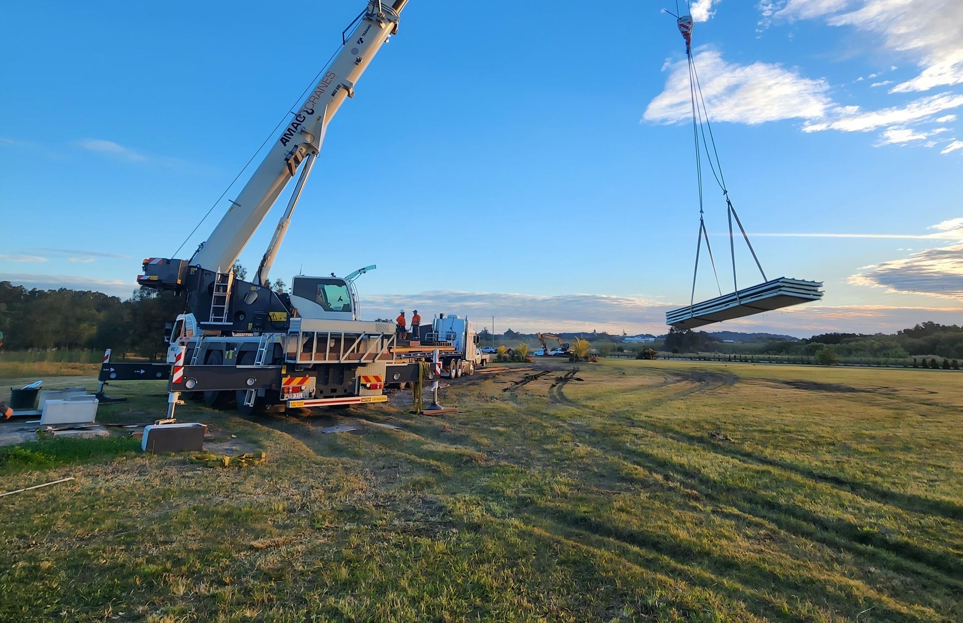 A Construction Worker Is Working on A Crane at A Construction Site — AMAC Cranes in Coolum Beach, QLD