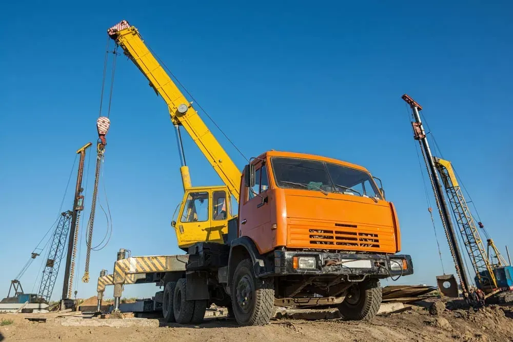 A Truck with A Crane Attached to It Is Parked on A Construction Site — AMAC Cranes in Coolum Beach, QLD