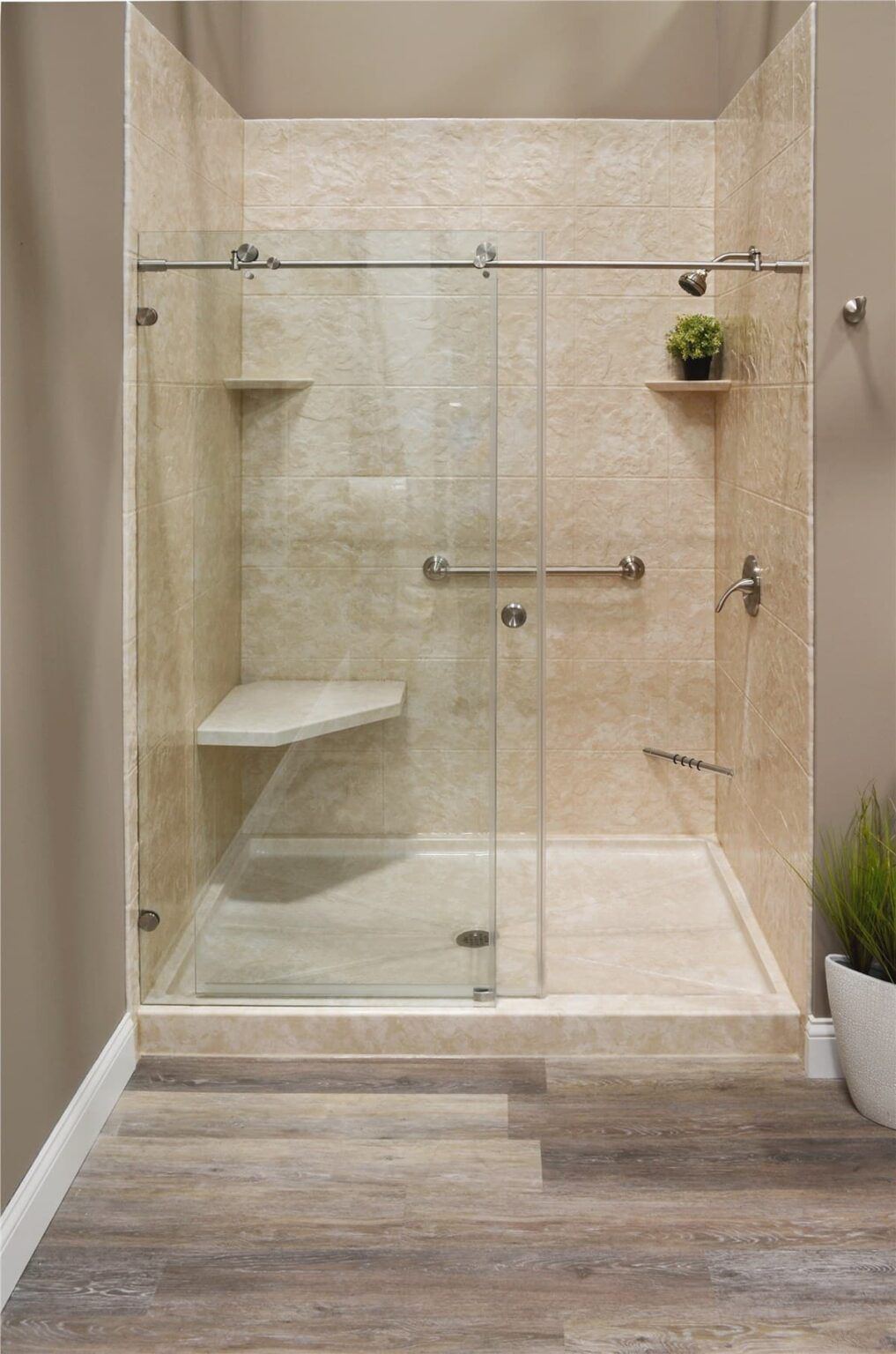 A bathroom with a walk in shower with a sliding glass door.