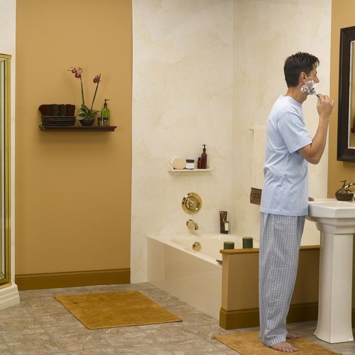 A man is brushing his teeth in a bathroom