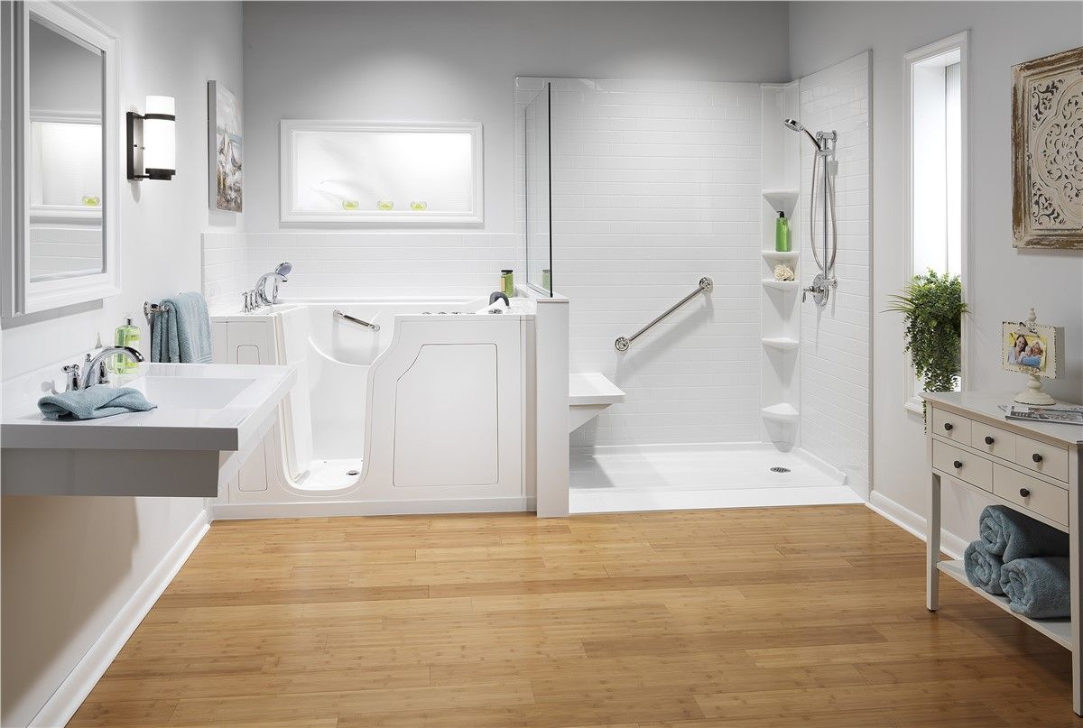 A bathroom with a walk in tub , sink , and shower.