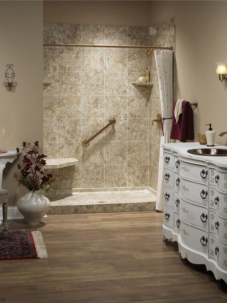 A bathroom with a walk in shower and a sink