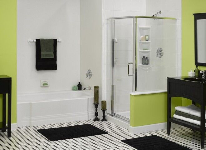 A bathroom with green walls and a walk in shower