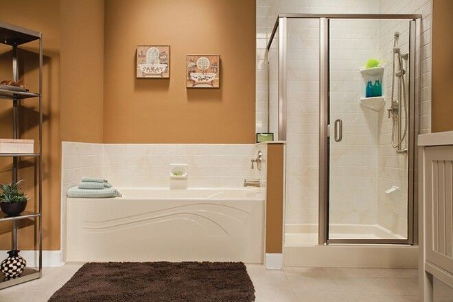 A bathroom with a bathtub and a walk in shower.