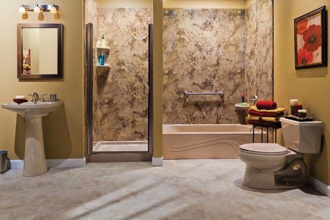 A bathroom with a toilet , sink and shower