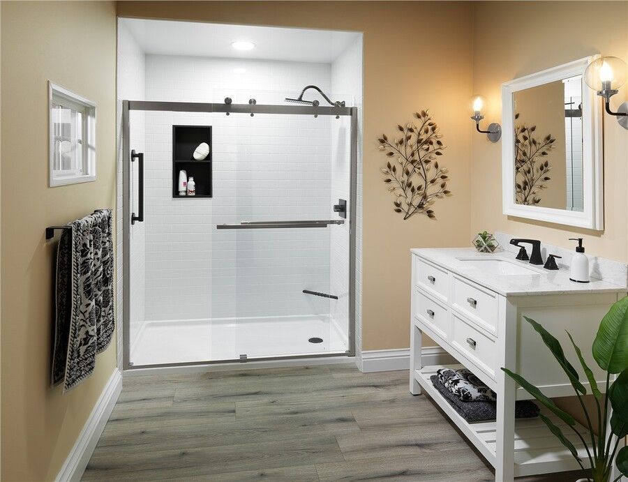 A bathroom with a sliding glass shower door and a sink.