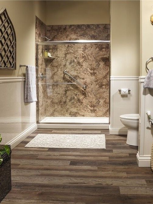 A bathroom with a walk in shower , toilet and bathtub.