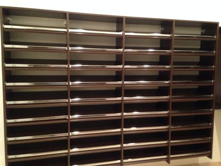 Empty wooden mail cubby shelves in a post office or office mailroom.