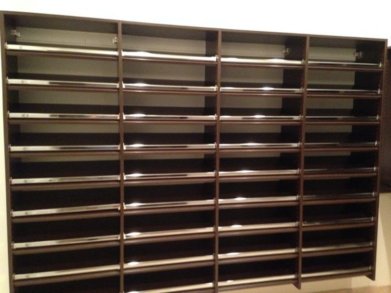Empty black metal mail sorter with rows of horizontal slots