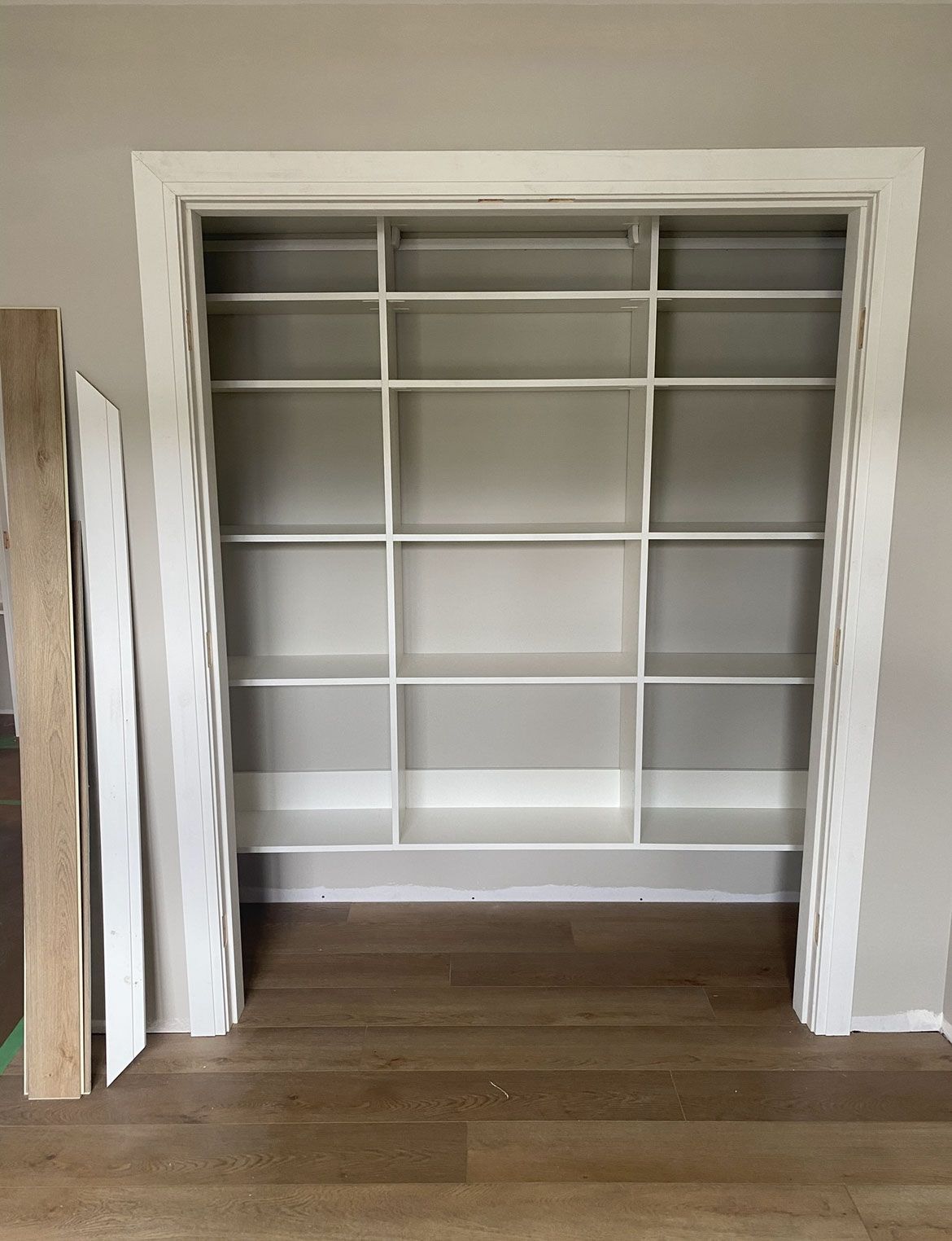 Empty built-in white closet shelves in a doorway