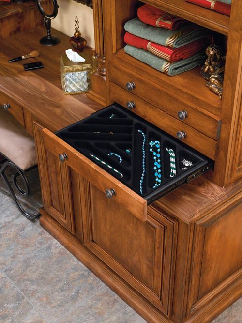 Wooden desk with a black illuminated tablet or display on the pull-out shelf