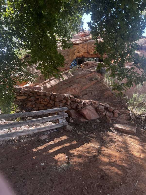 A cave entrance tucked beneath cottonwood trees on the homestead