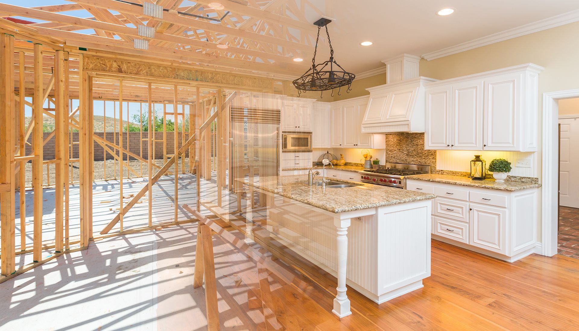 Kitchen under construction with completed white cabinetry, island, and wood floors.