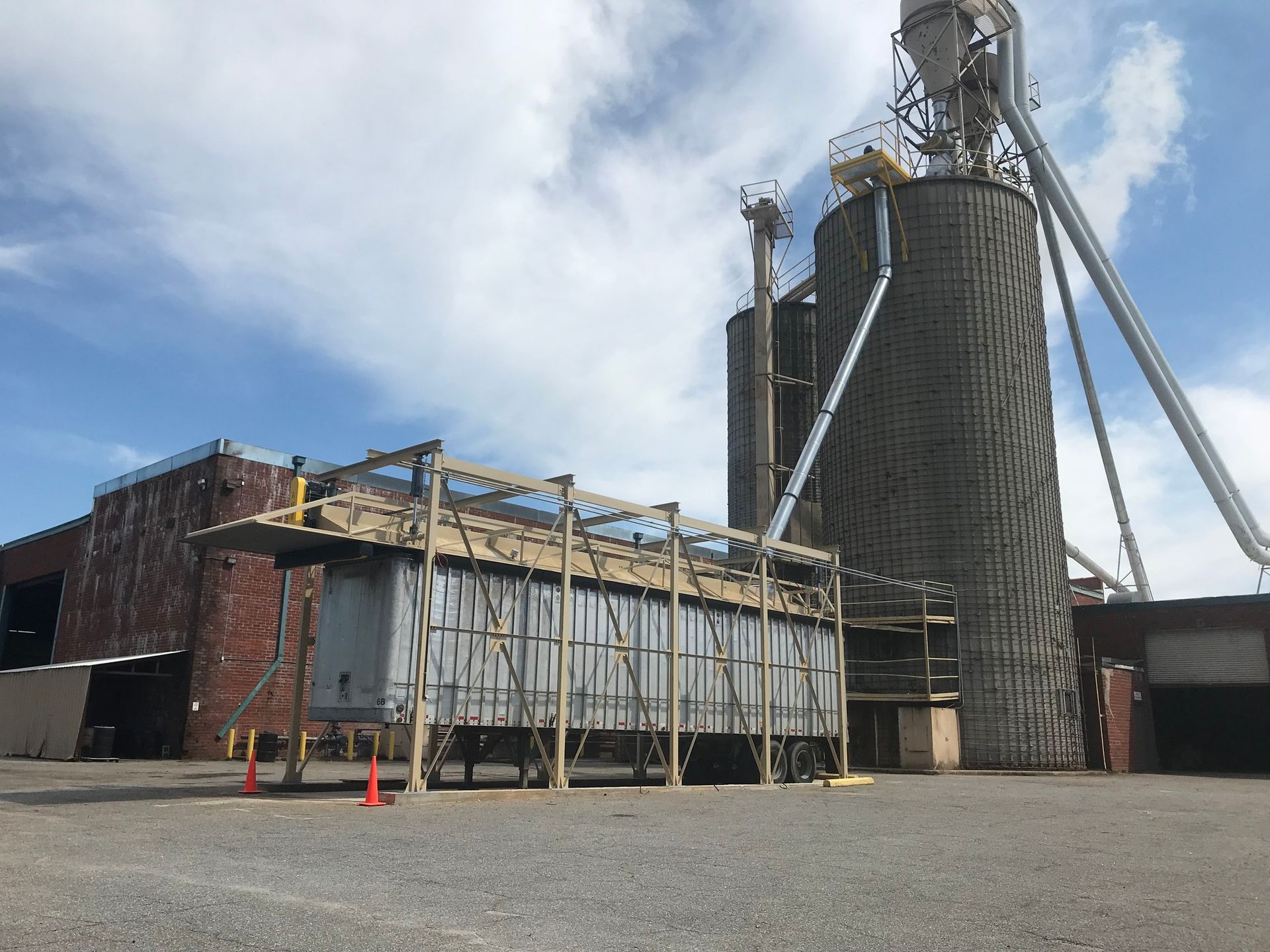 Grain silos and industrial structure in outdoor setting, overcast sky.