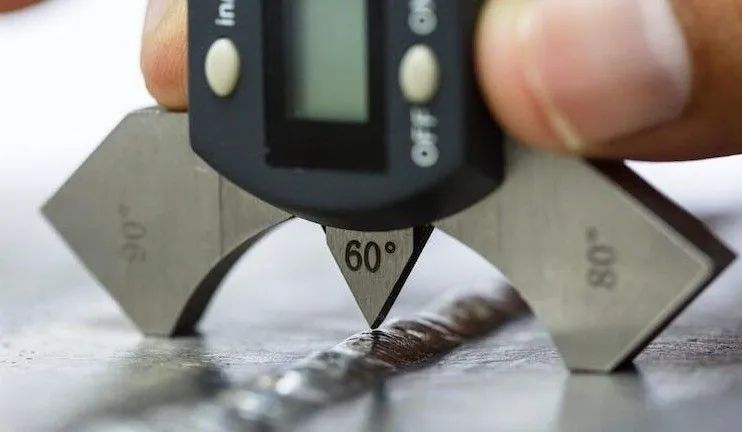 Digital angle gauge measuring a sharp metal edge at 60 degrees on a workbench