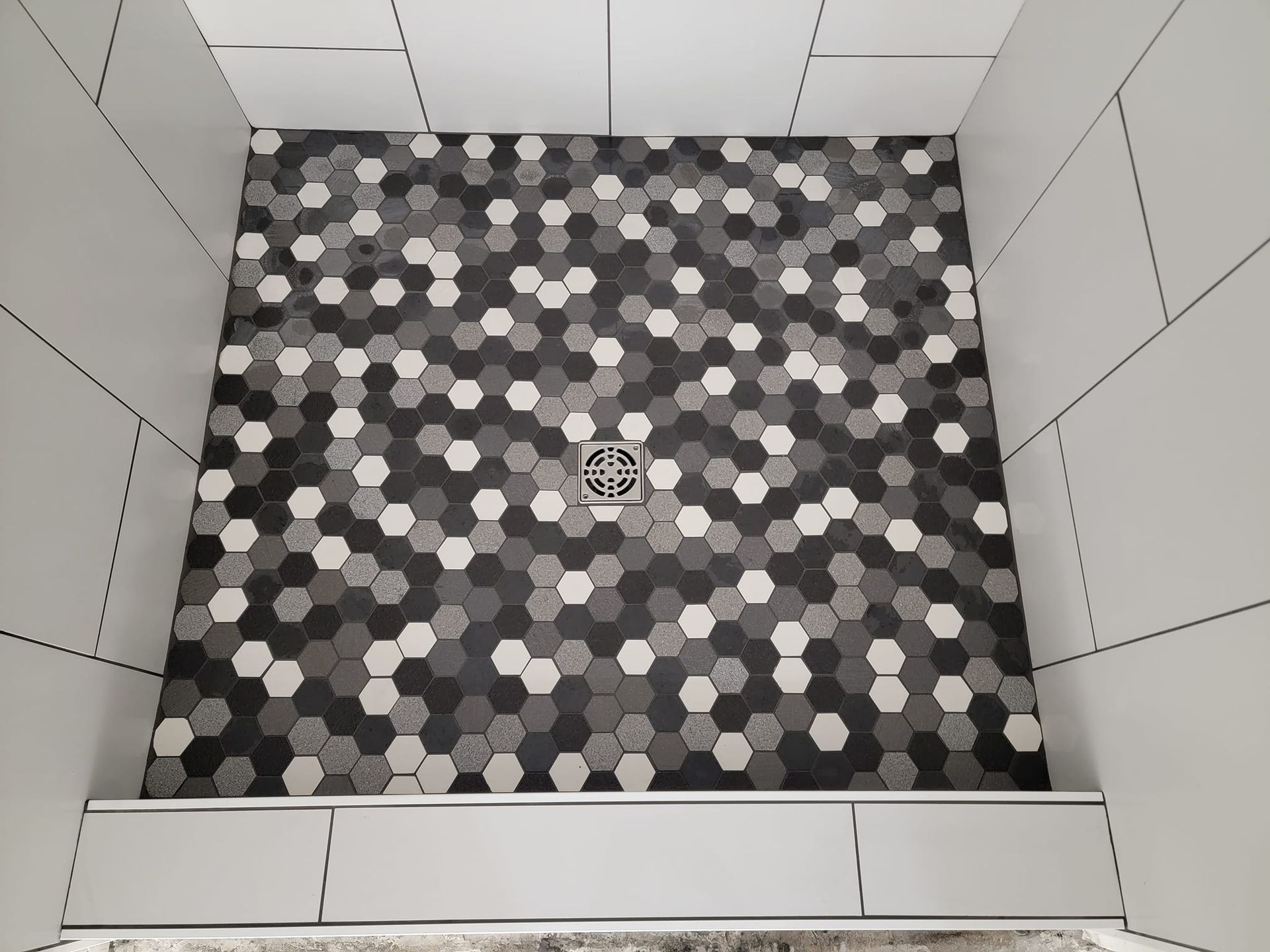 Tile floor in tiled shower