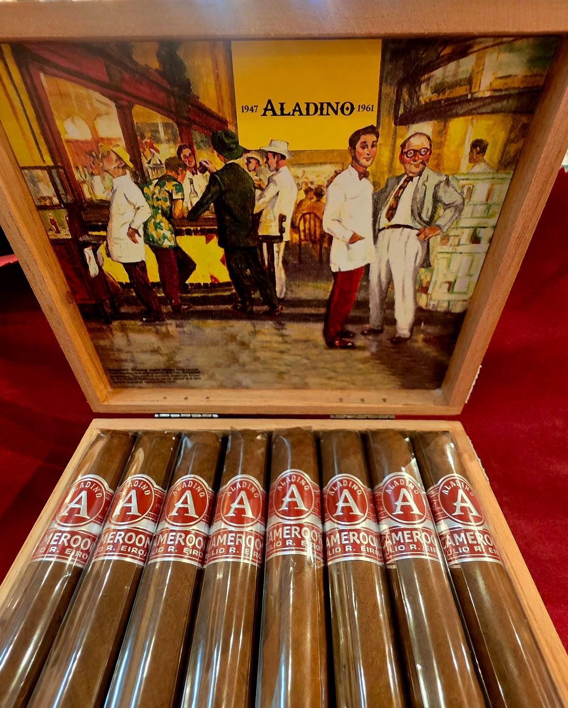 Three brown cigars with gold bands arranged diagonally on a dark background