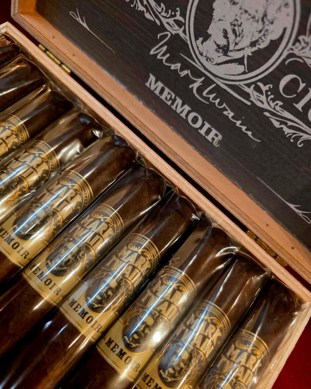Close-up of assorted cigars in a warmly lit display case