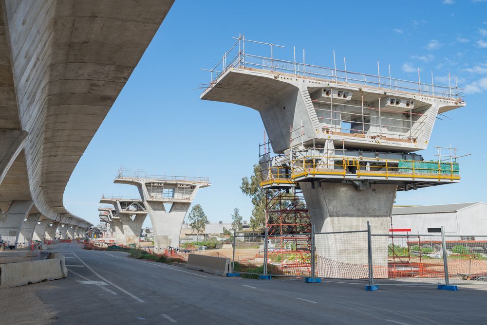 Concrete Elevated Highway Under Construction Against a Blue Sky — Top Tier Scaffolding In Ipswich, QLD