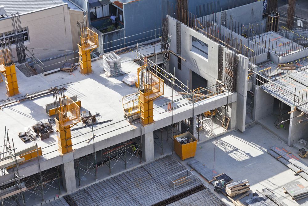 Construction Site With Yellow Scaffolding and Equipment — Top Tier Scaffolding In Ipswich, QLD