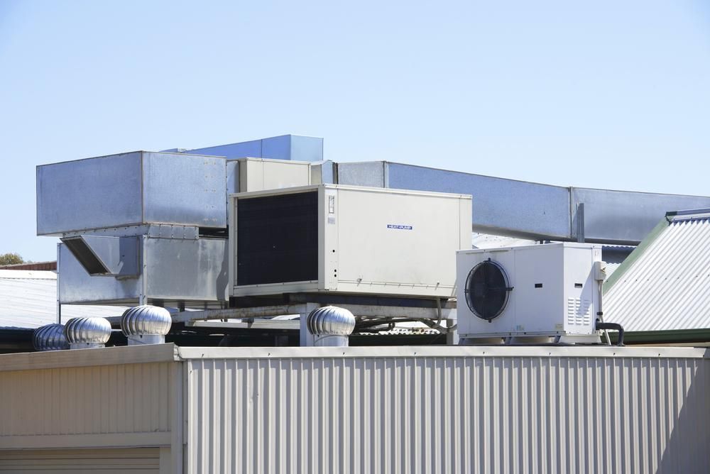 A Large Air Conditioner Is Sitting On Top Of A Building — Jervis Bay Airconditioning In Sussex Inlet, NSW