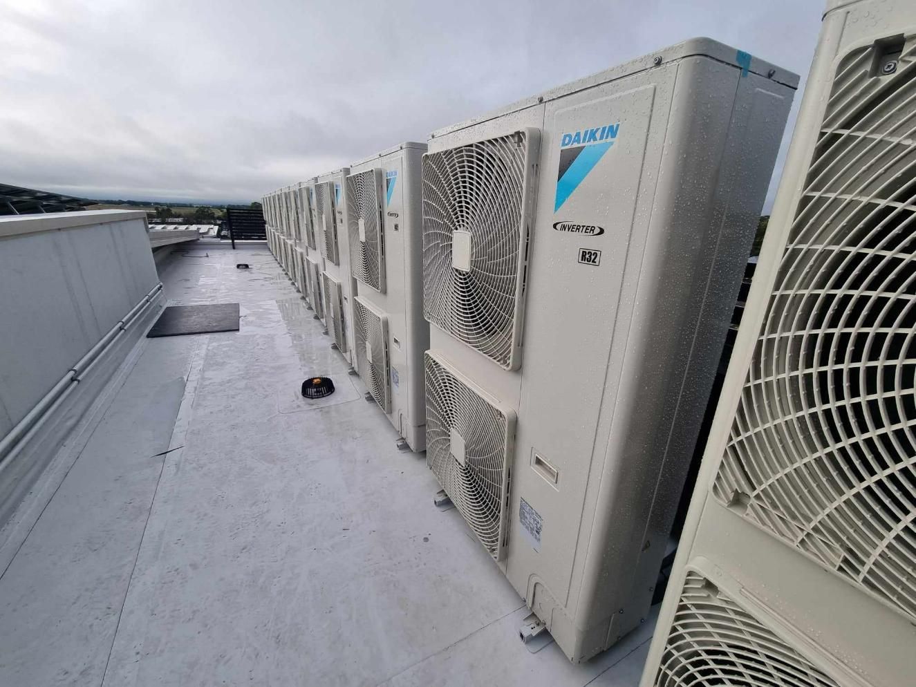 A Row Of Air Conditioners Are Sitting On Top Of A White Roof — Jervis Bay Airconditioning In Huskisson, NSW