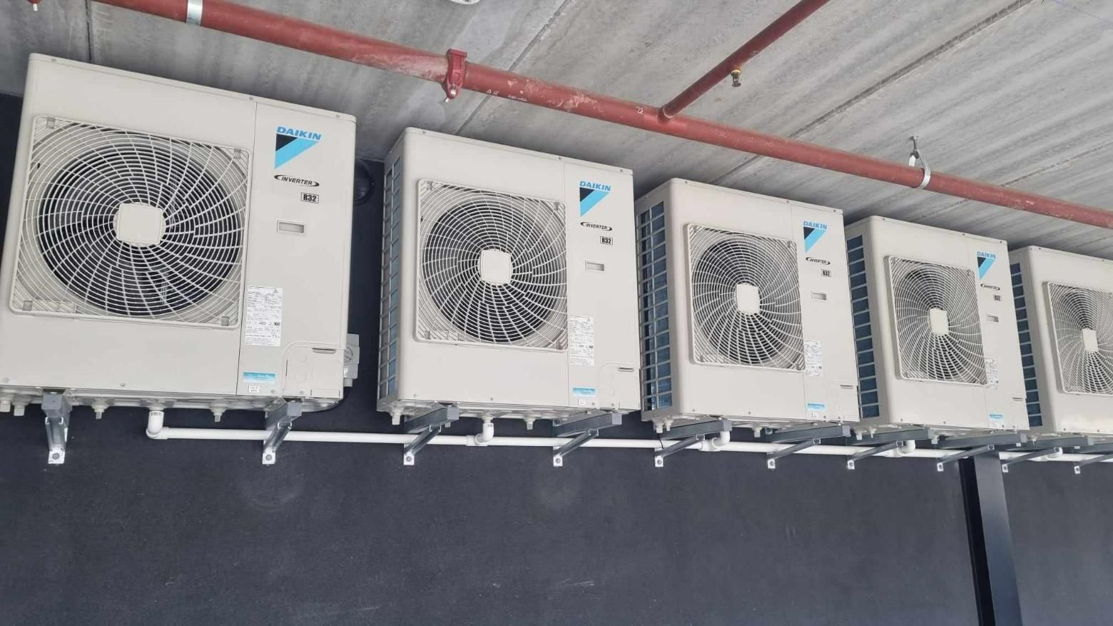 A Row Of Air Conditioners Hanging From The Ceiling Of A Building — Jervis Bay Airconditioning In Huskisson, NSW