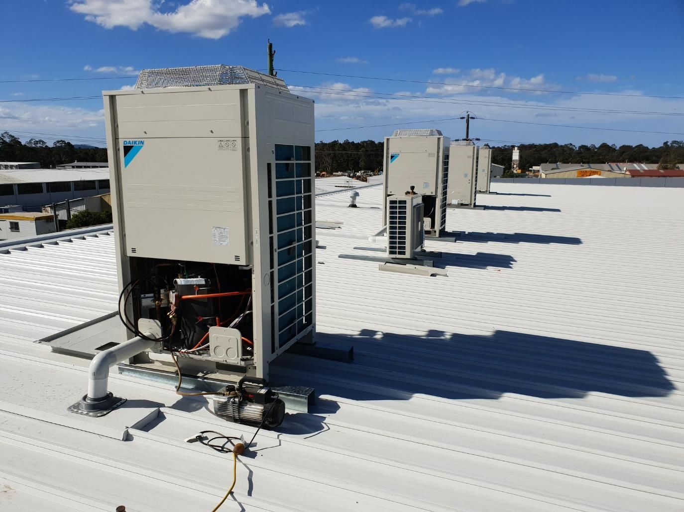 A Row Of Air Conditioners On Top Of A White Roof — Jervis Bay Airconditioning In Sanctuary Point, NSW