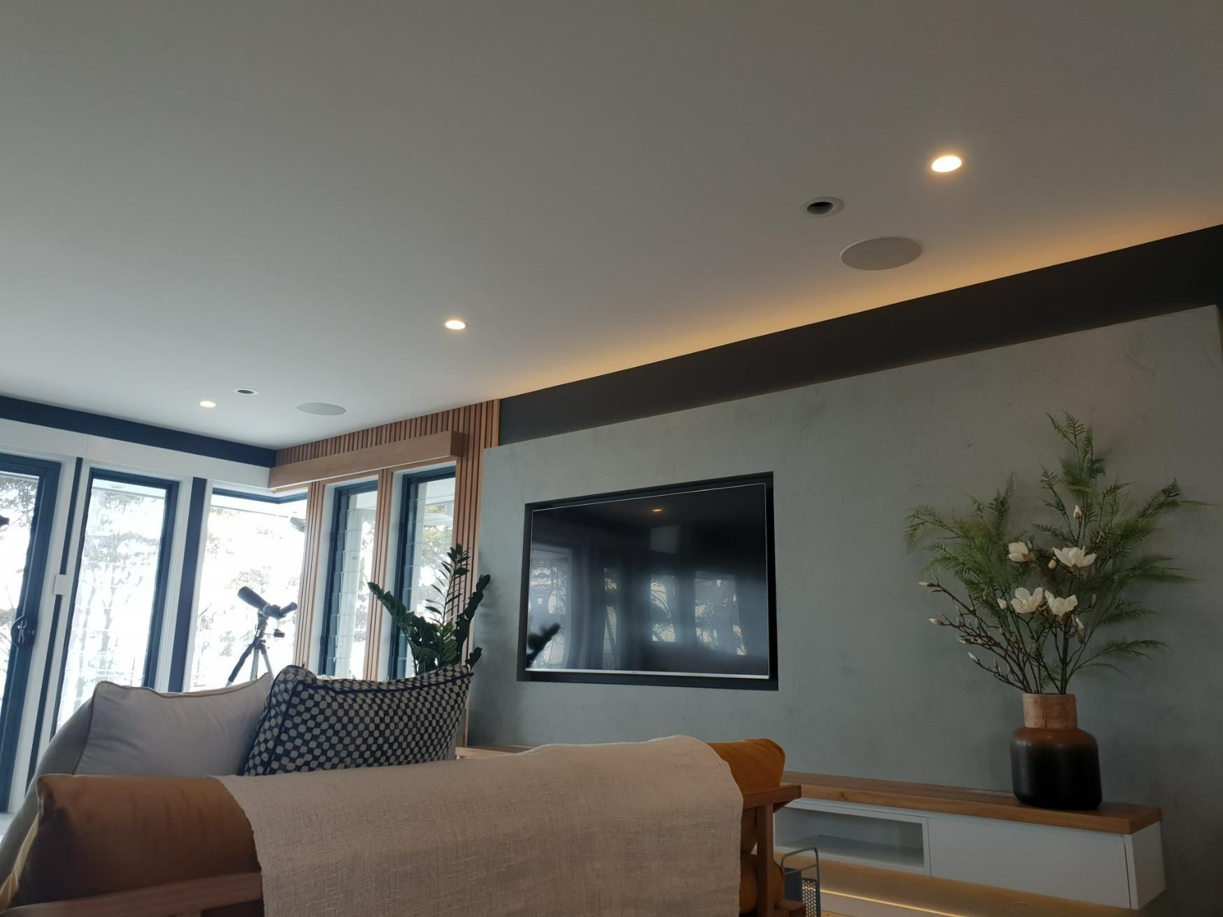 A Living Room With A Couch And A Flat Screen Tv On The Wall — Jervis Bay Airconditioning In Huskisson, NSW