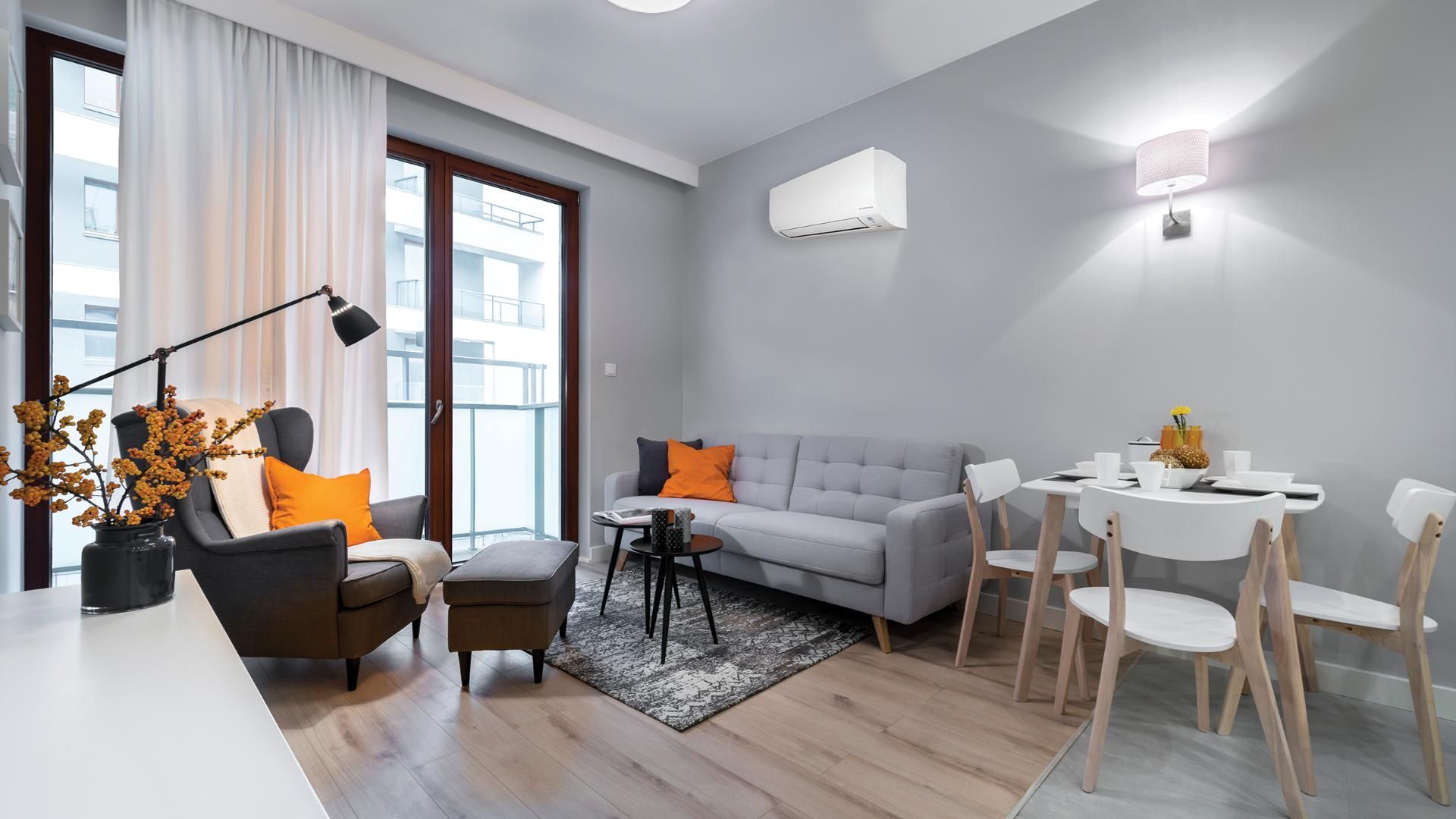 A Living Room With A Couch, Chair, Table — Jervis Bay Airconditioning In Ulladulla, NSW