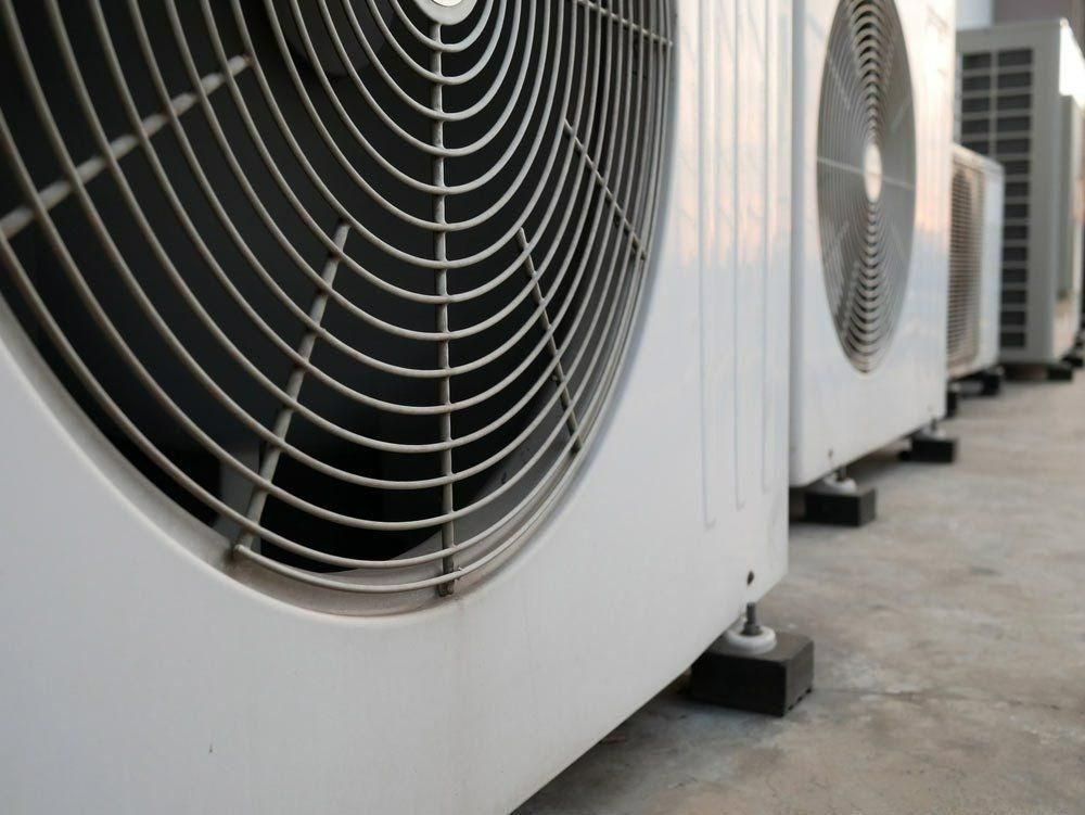 A Row Of Air Conditioners Are Lined Up On The Ground — Jervis Bay Airconditioning In Huskisson, NSW