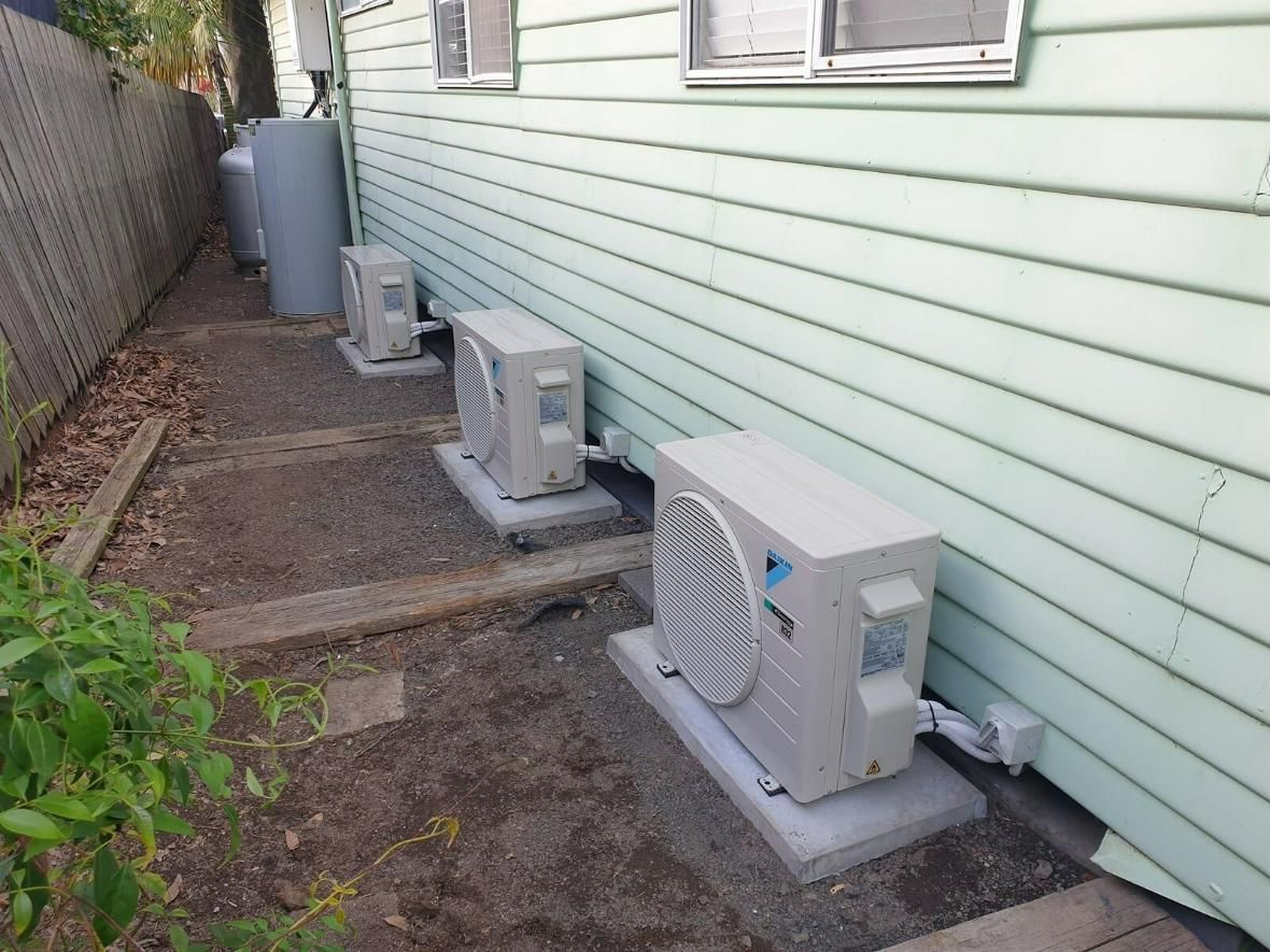 Three Air Conditioners Are Sitting On The Side Of A House — Jervis Bay Airconditioning In Albion Park, NSW