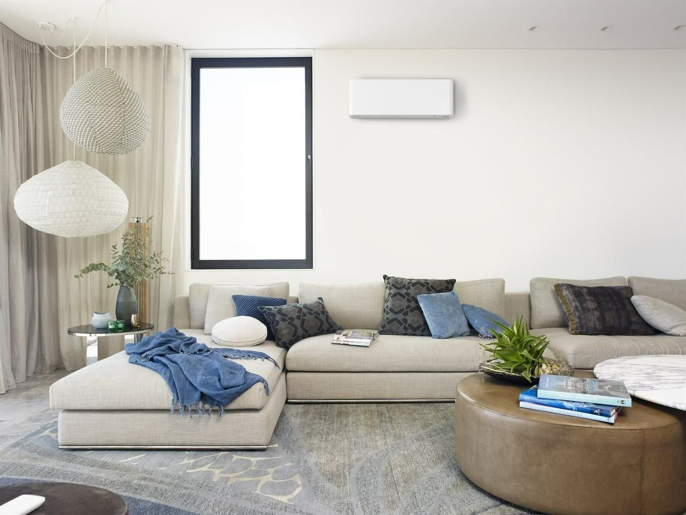 A Living Room With A Couch, Coffee Table, And Window — Jervis Bay Airconditioning In Albion Park, NSW