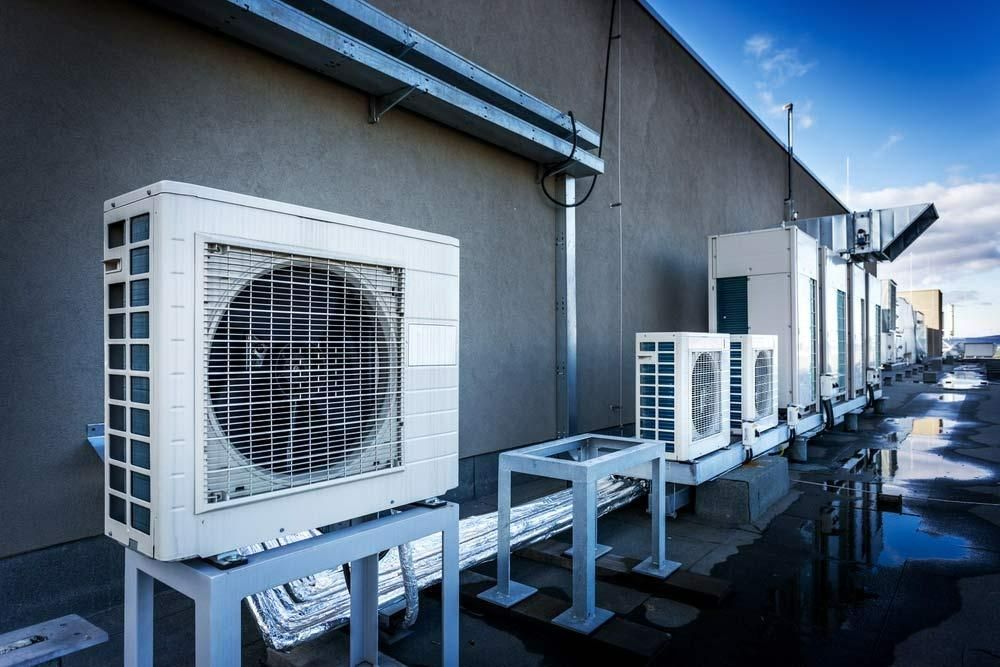 A Row Of Air Conditioners Are Sitting Outside Of A Building — Jervis Bay Airconditioning In Kiama, NSW