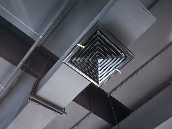 A Square Air Vent Is Hanging From The Ceiling Of A Building — Jervis Bay Airconditioning In Kiama, NSW