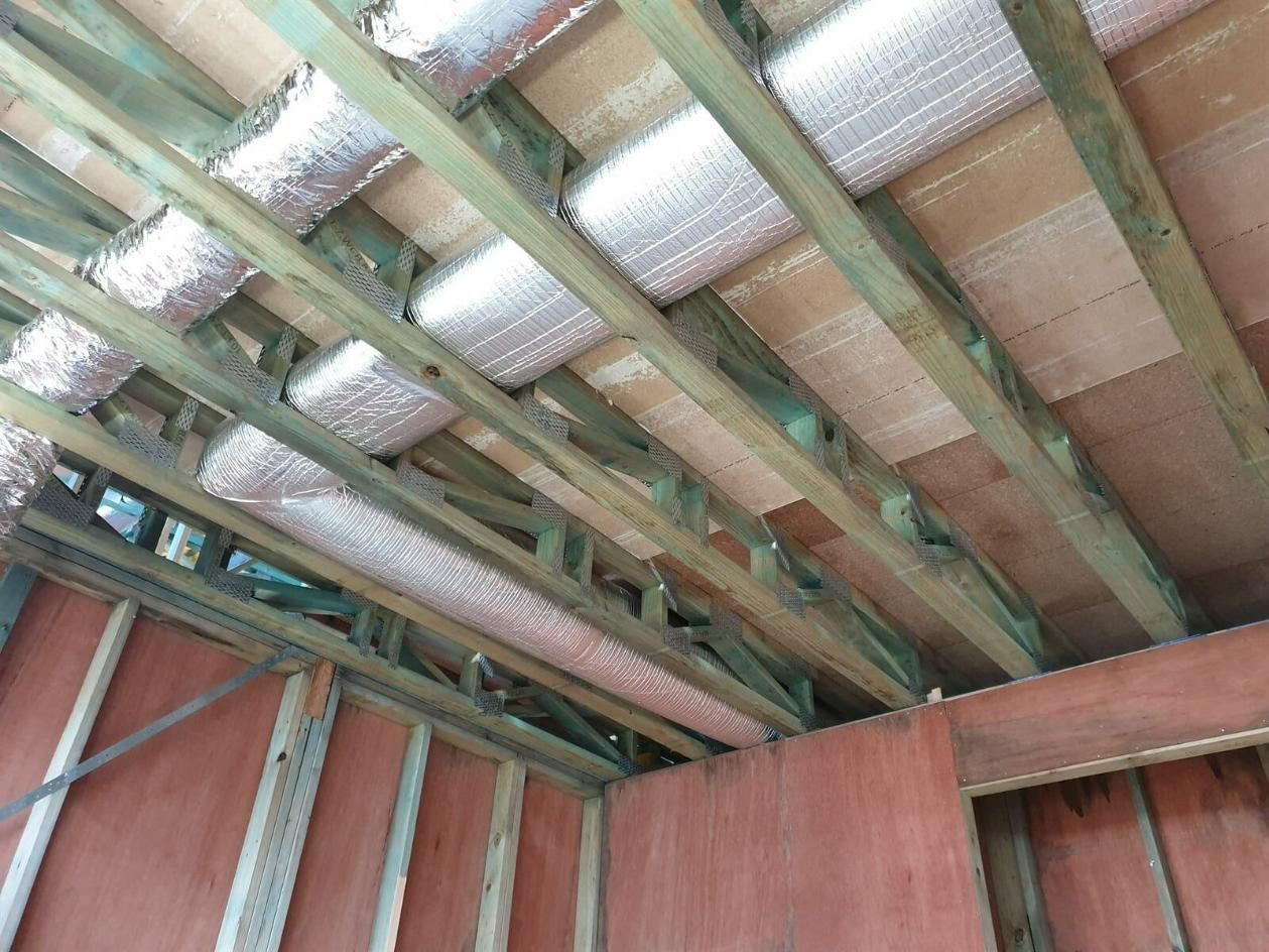 The Ceiling Of A Building Under Construction With Wooden Beams And Insulation — Jervis Bay Airconditioning In Huskisson, NSW