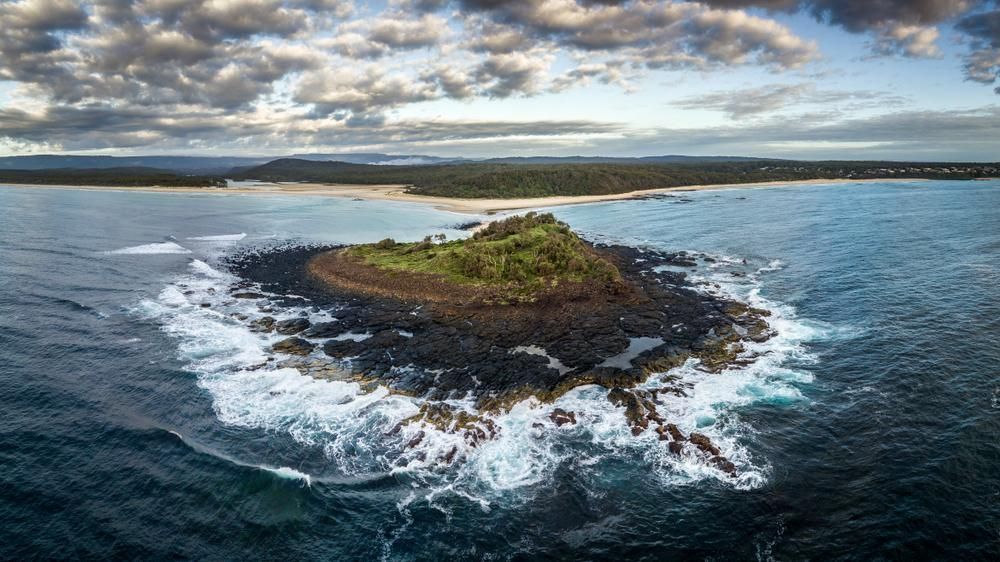 An Aerial View Of A Small Island In The Middle Of The Ocean — Jervis Bay Airconditioning In Ulladulla, NSW