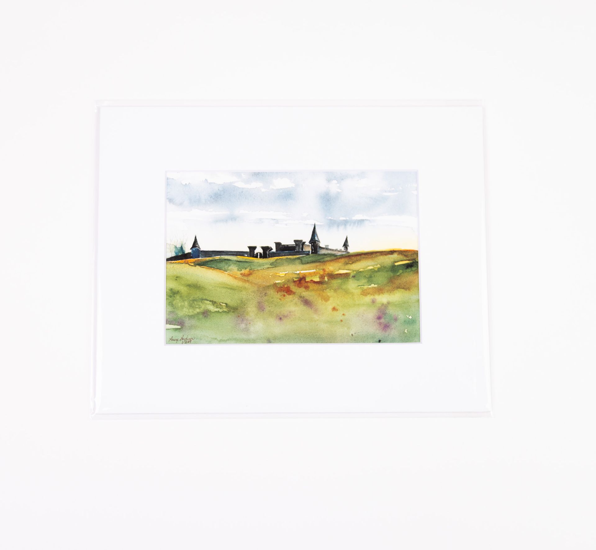 Watercolor landscape painting with a field and distant buildings.