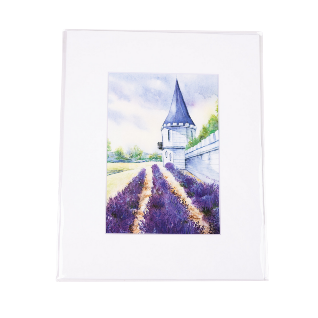 Lavender field with tower and white wall.