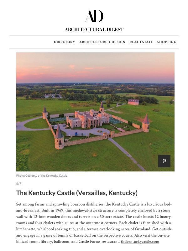 Aerial view of the Kentucky Castle, a stone structure in Versailles, Kentucky, with a surrounding wall and landscape.